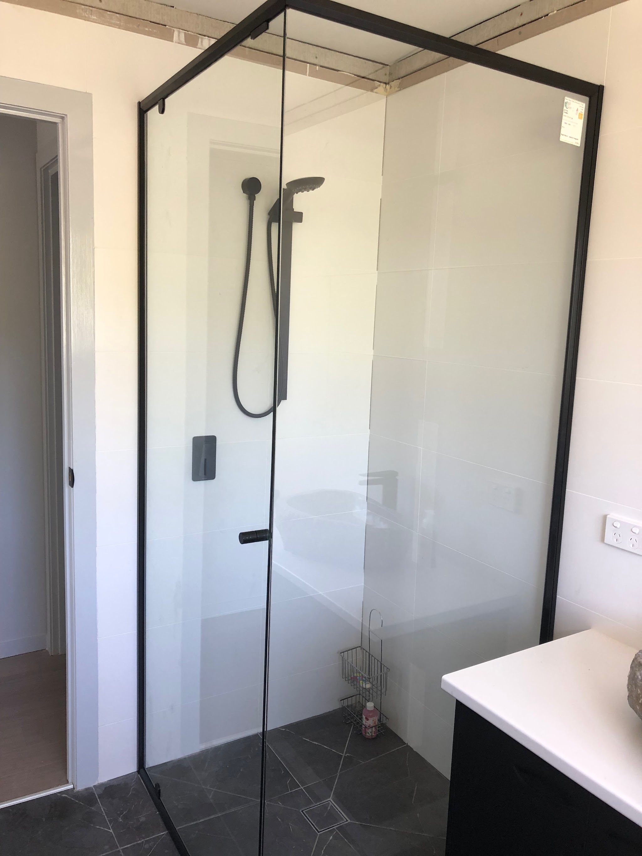 Frameless corner shower screen installed during a bathroom renovation
